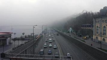 nebbioso strada con traffico di dnieper fiume nel kiev, Ucraina video