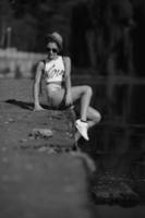 beautiful girl sitting on the pier photo