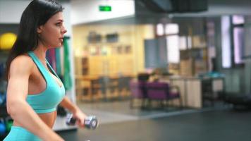 Fitness woman in active wear working out at gym video