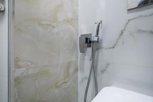 bidet in modern toilet with  wall mount shower attachment photo