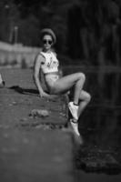 beautiful girl sitting on the pier photo