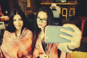 two close friends do selfie in the cafe photo