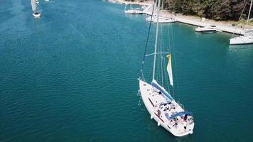 Sailing yacht sails on sparkling water on bright sunny day video