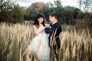 Lovely couple spends time in the field photo