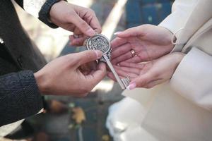 groom gives the bride a key photo