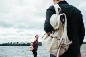 two young guys standing on a pier photo