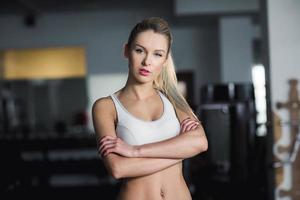Beautiful athletic girl  poses in the gym photo