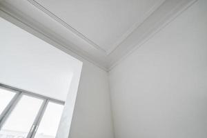 corner of ceiling cornice with intricate crown molding. photo