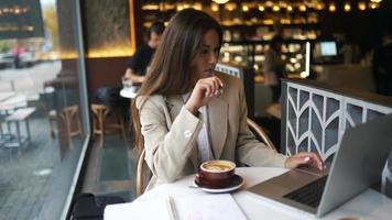 Woman working sitting in coffee shop video