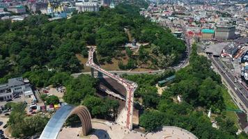Aerial slow zoom of pedestrian bridge and landmarks in Kyiv Ukraine video