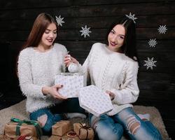 two beautiful girls together unpack gifts photo