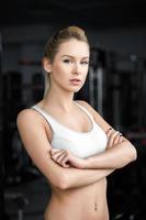 Beautiful athletic girl  poses in the gym photo