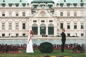 Wedding couple on a walk in the estate of the Belvedere in Vienna photo
