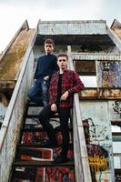 two guys stand in an abandoned building photo