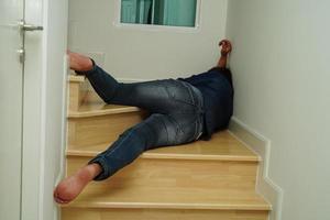 Asian lady woman injuries from falling down on slippery surfaces stairs at home. photo