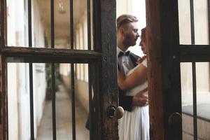 Groom and gorgeous brine in hotel room photo