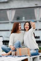 Two girls make selfie with gifts photo