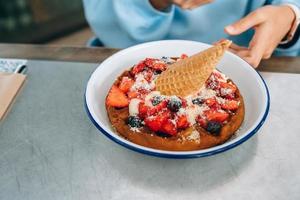 Freshly baked pie with various berries and ice cream on a white plate. photo