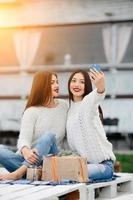 Two girls make selfie with gifts photo