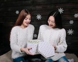 two beautiful girls together unpack gifts photo