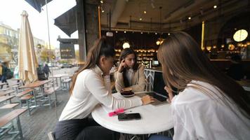 Three women having a meeting at coffee shop video