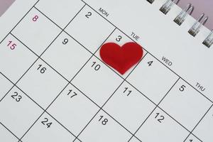 Red heart shape on the date of the 3rd day in the calendar. photo