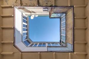 up view on balcony in yard on blue sky, look at the house from the bottom up photo