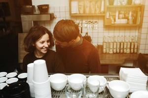 Vintage couple preparing coffee with vacuum coffee maker.Coffee shop photo