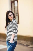 Beautiful model in a striped sweater in glasses photo