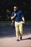 bearded man walks through the city photo