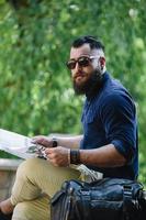 bearded man looking at a map photo