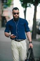 bearded man goes and listens to music photo