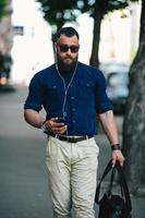 bearded man goes and listens to music photo