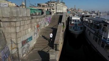 Woman runs up and down outdoor concrete steps for exercise video