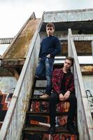 two guys stand in an abandoned building photo