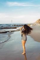 Young beautiful girl posing by the sea photo