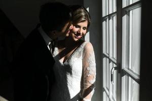 bride and groom on the background of a window. photo