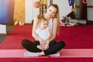 Mom and daughter together perform different exercises photo