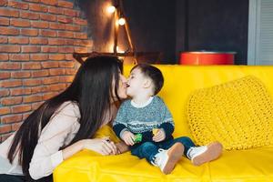 Mother and little son play at home photo