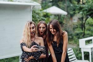 Three girls discuss photo