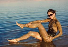 A young woman enjoying the natural mineral mud photo