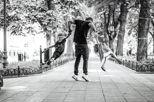 Children having fun with dad in the park photo