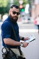 bearded man with a map in hand photo