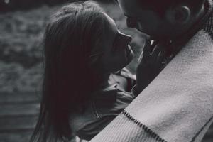 Young couple wrapped in plaid photo