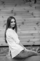 girl posing against background of a wooden wall photo