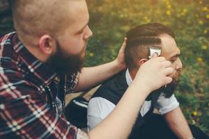 barber shaves a bearded man photo