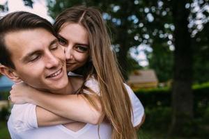 Young adult brunette man and woman in the park photo