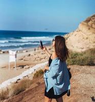 Young woman take a photo on smartphone