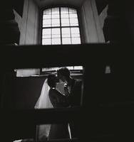 bride and groom on the background of a window. photo
