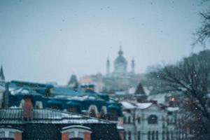 Copious snowfall over the city with the roofs photo